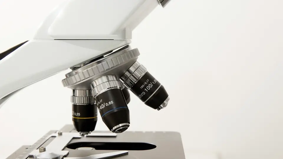 A microscope on a white bench